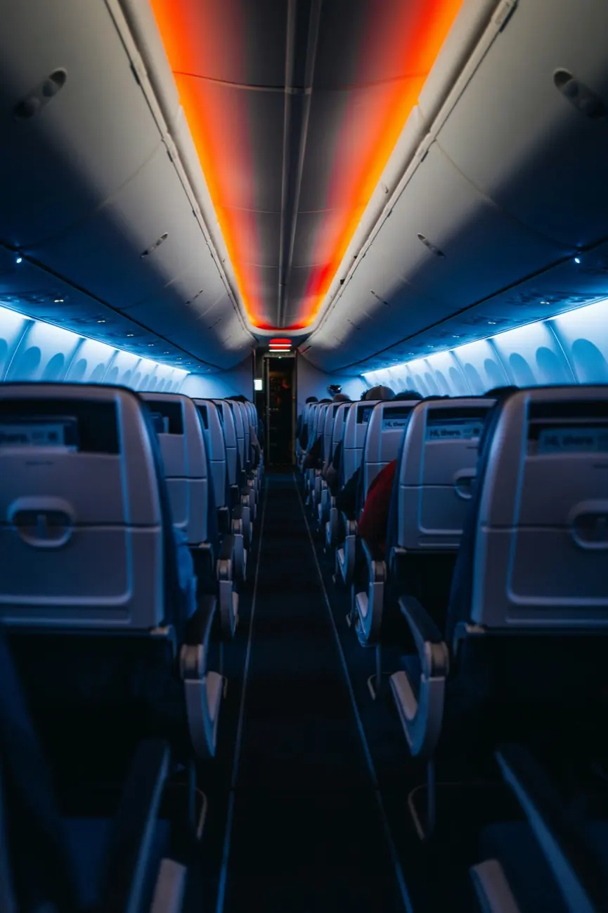 Empty aircraft cabin lit in orange and blue